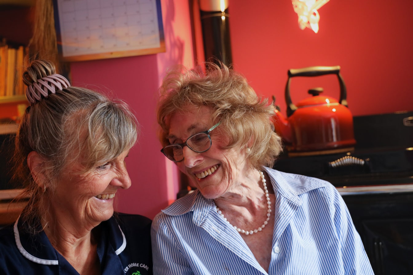 Carer and client smiling