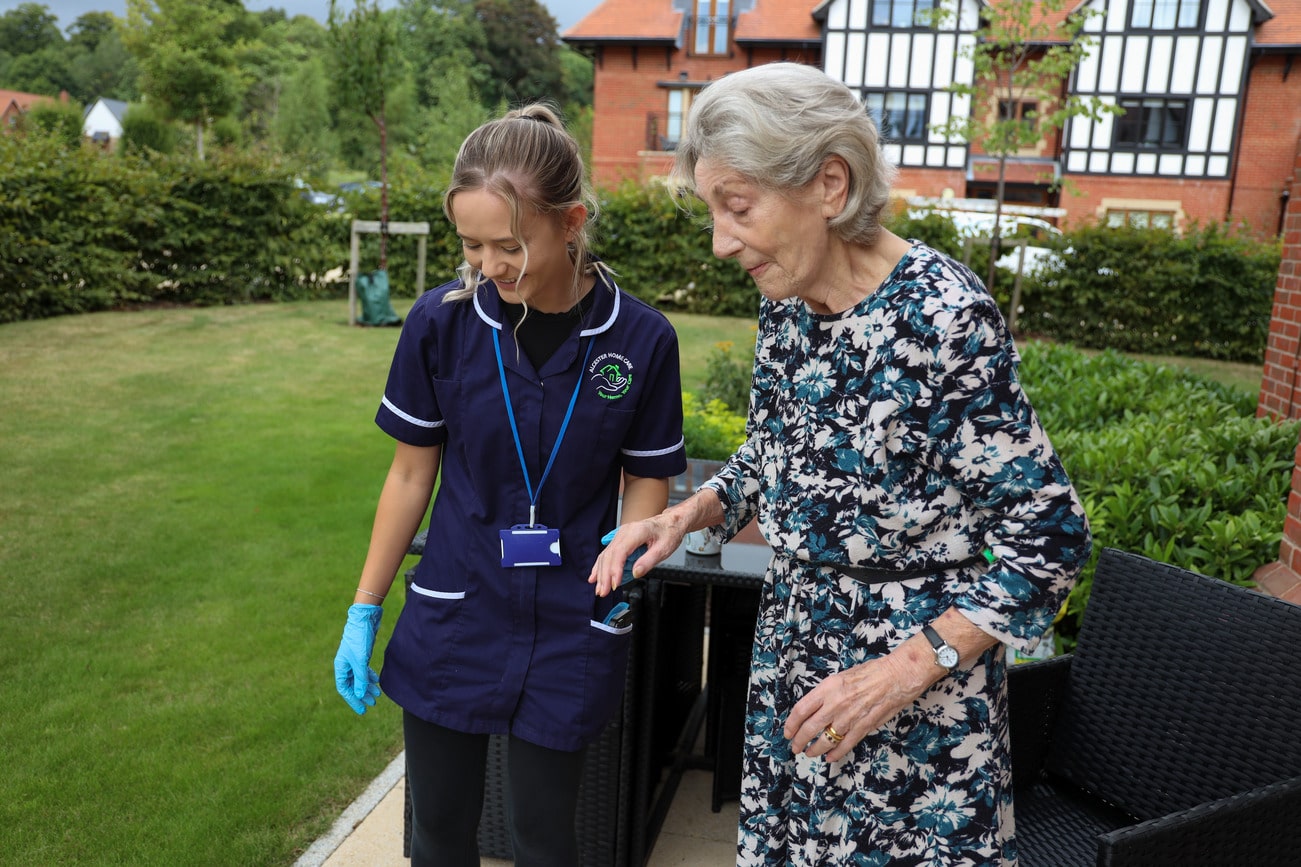 Carer with elderly client in garden