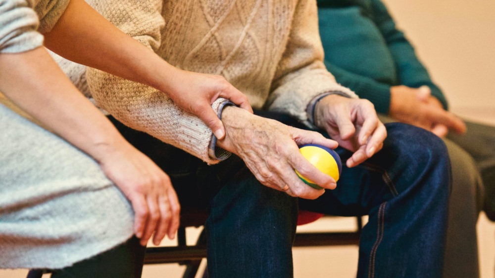 Carer holding hand