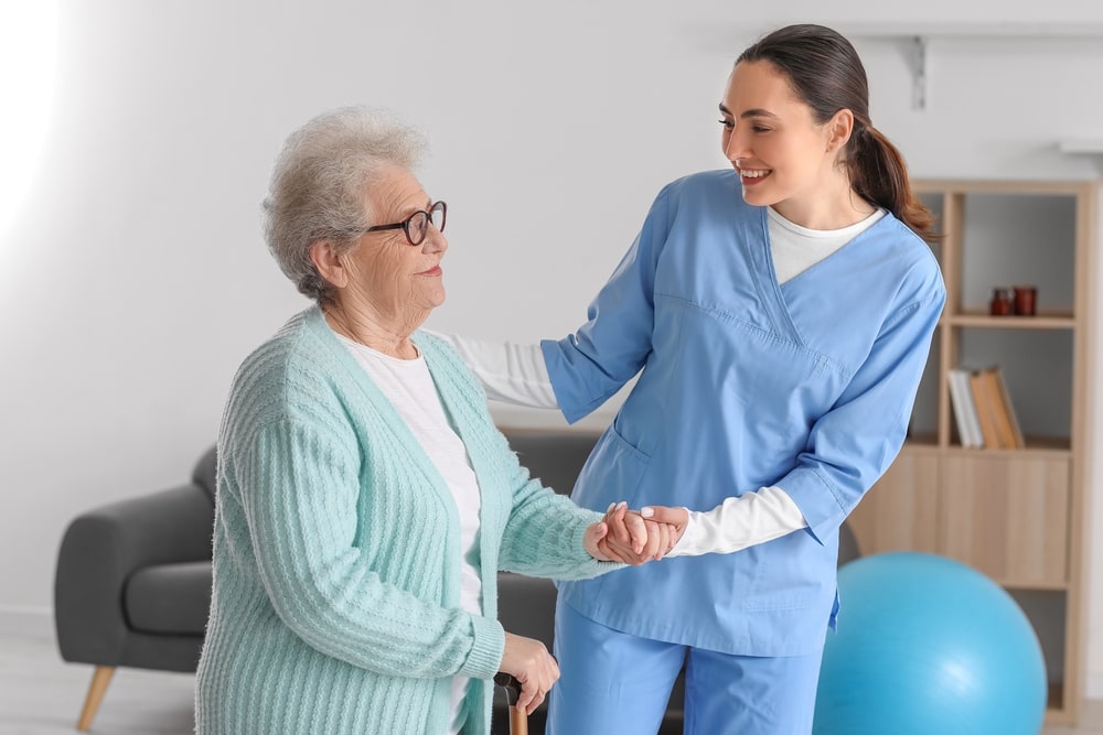 carer helping elderly lady at home