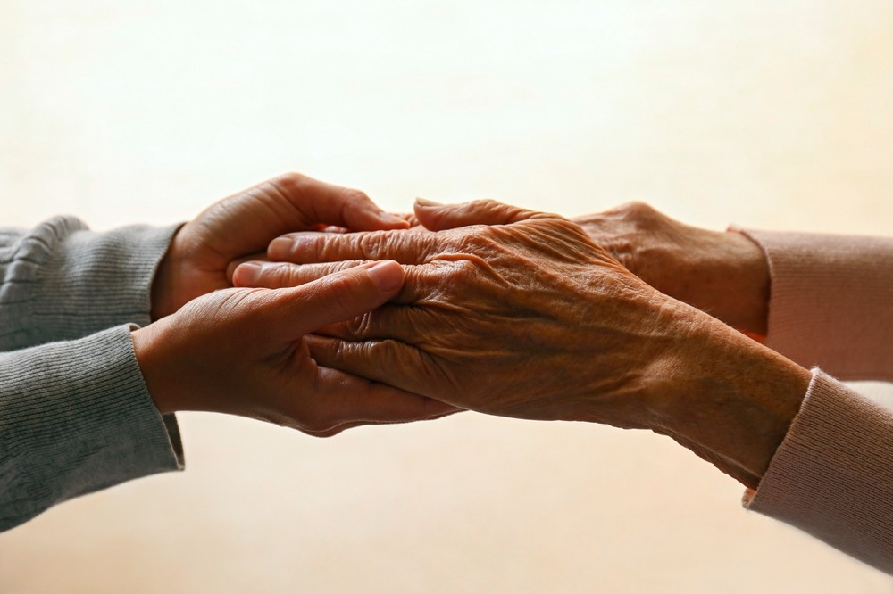 elderly people holding hands