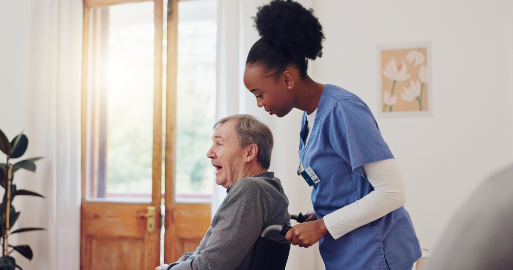 carer pushing elderly man in a wheelchair