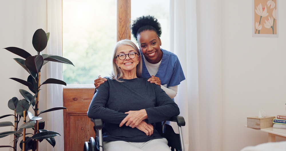 carer hugging woman in wheelchair